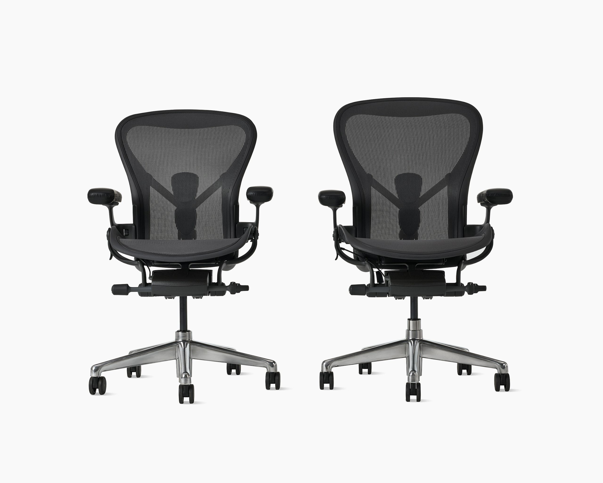 Aeron ESD size B and Aeron ESD size C chairs in graphite beside each other.