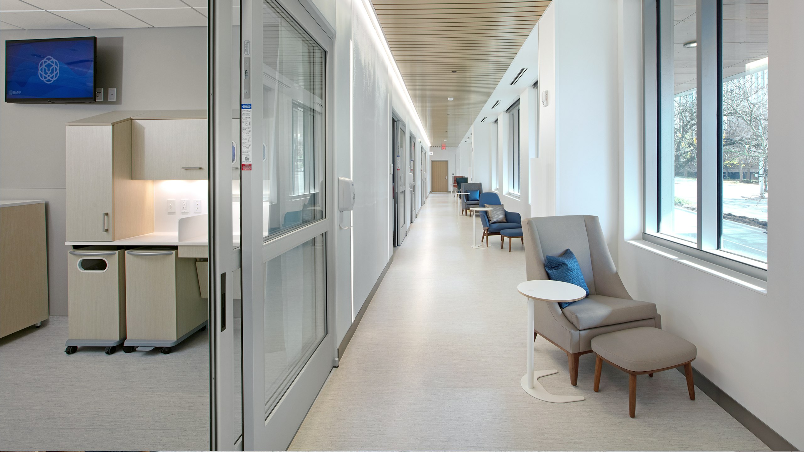 A hallway of exam rooms and chairs at BAMF Health